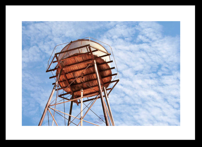 Buy or Rent Landscape Photography Wall Art of an abandoned water tower taken against a feathery blue sky taken at Big Bell, a ghost town in Western Australia located approximately 30 km south west of the town of Cue. Available on Fine Art Paper, Canvas & Acrylic